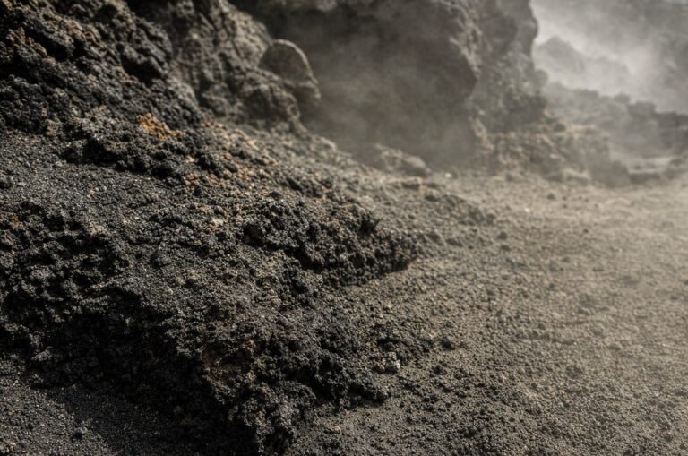 Close-up texture of black volcanic lava rock and ash